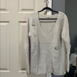 Grey knit sweater with accented rips
